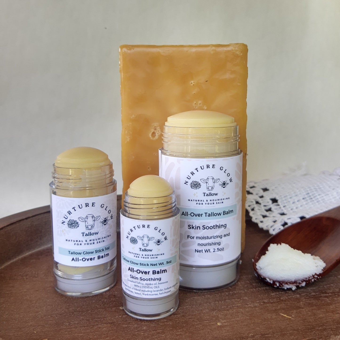 Three containers of Nurture Glow balm sticks on a wooden surface with a white background